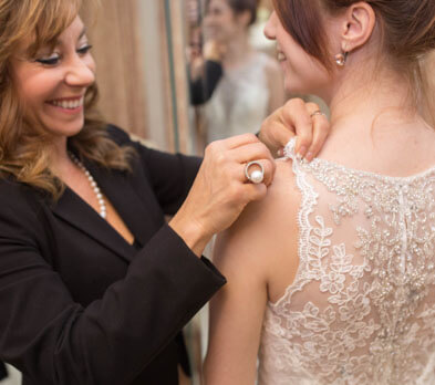Women straightens bride's dress